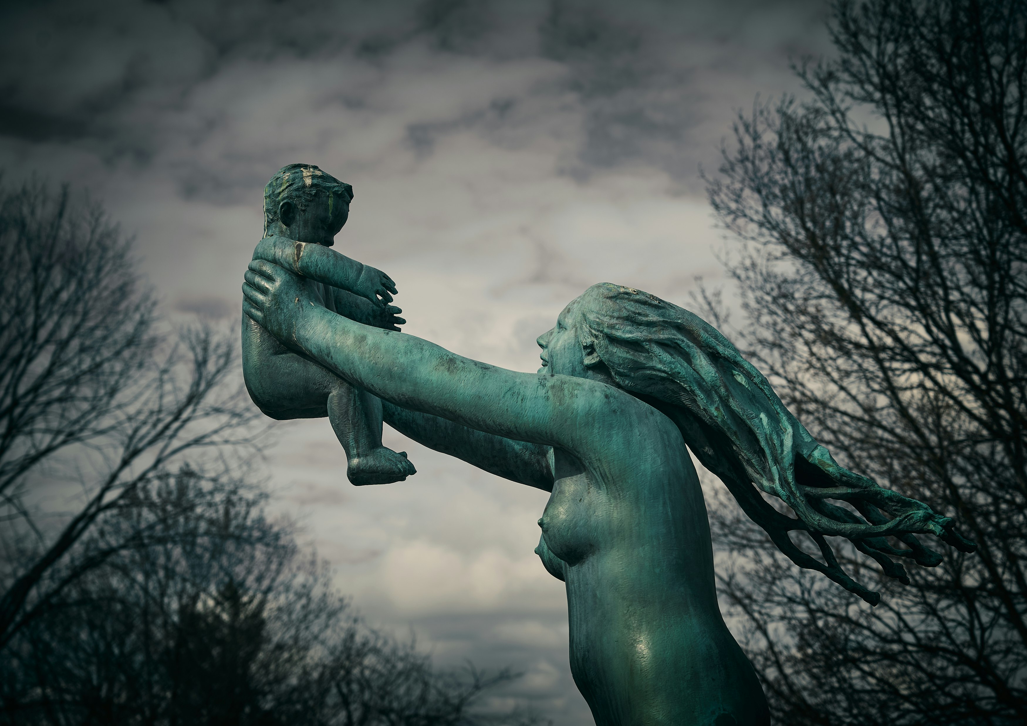 statue of man holding book